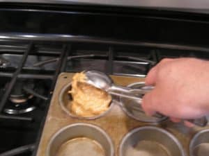 Scooping the batter into the muffin pan