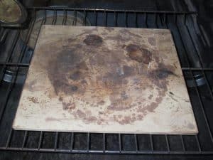 A pizza fairly well used stone froim a foodie store