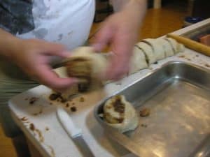 Put the segments into 9 x 13" pan.  Optionally, if you have a large muffin or mini-cake pan, you can put the segments into separate cups in the pan.  This makes it easier to separate and serve the rolls later.
