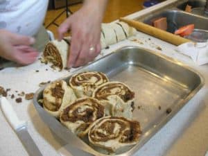 Keep going. Once it's all filled up put any spilled nuts, fruit or sugar mix on top of the rolls. 
