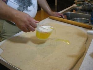 Pour the melted and cooled butter onto the dough