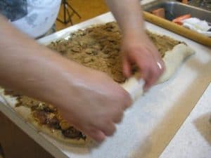 Roll the 24" side towards you, like a jelly roll.  Or, perhaps, a cinnamon roll.