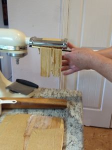 Pasta being cut into fettuccine