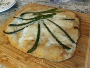 An asparagus pizzza, ready for baking